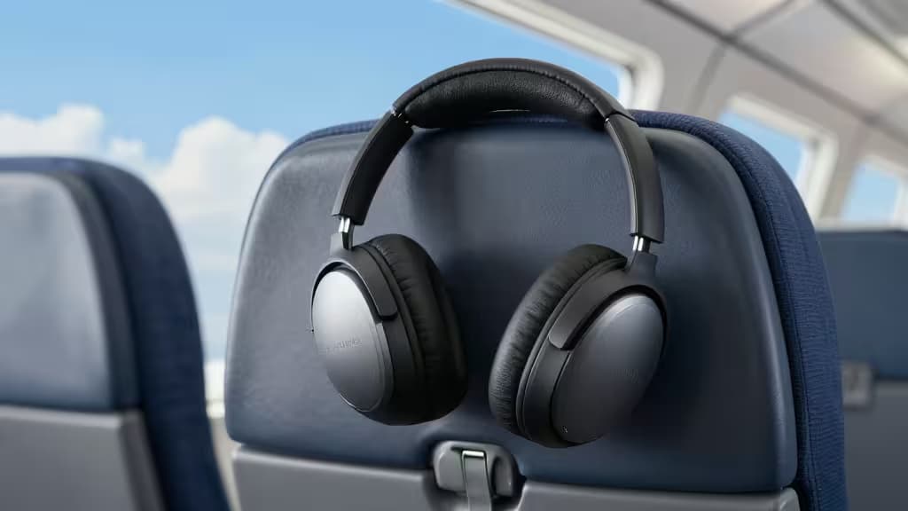 Casque antibruit noir sur siège d'avion, idéal pour voyages tranquilles sous 150$.