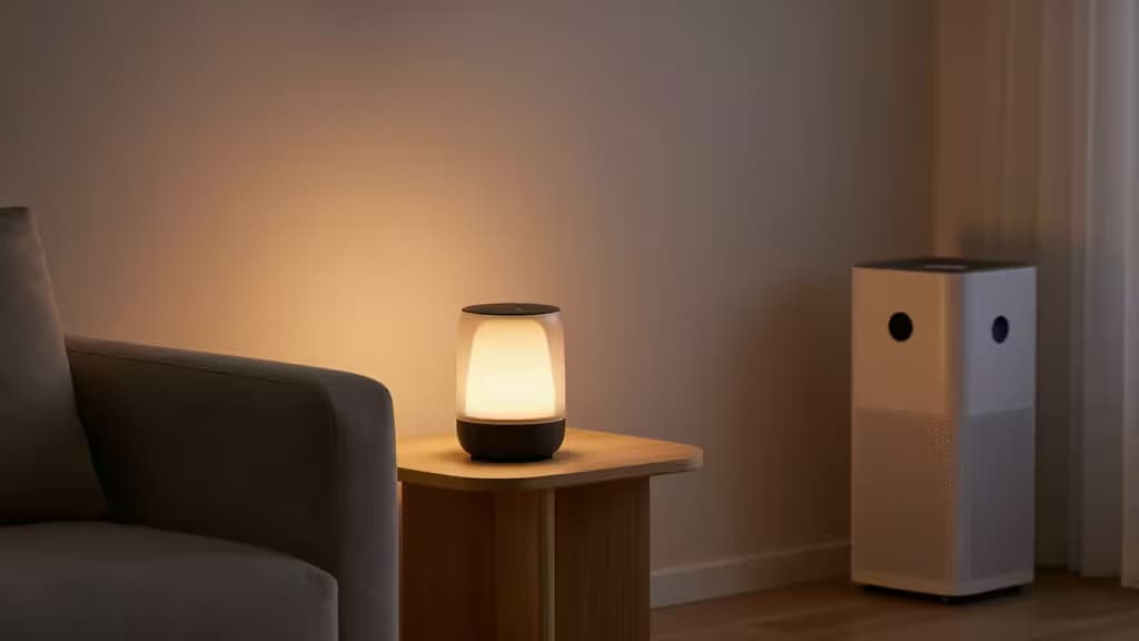A glowing smart lamp and air purifier create a serene, tech-enhanced living room ambiance.