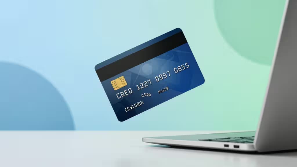 A blue credit card floats above a laptop, symbolizing accessible business financing for startups with no credit history.