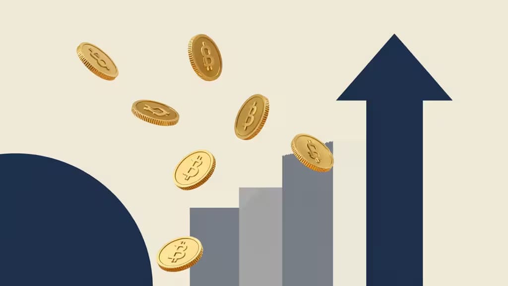Golden Bitcoin coins float upward beside a rising blue arrow and bar chart.
