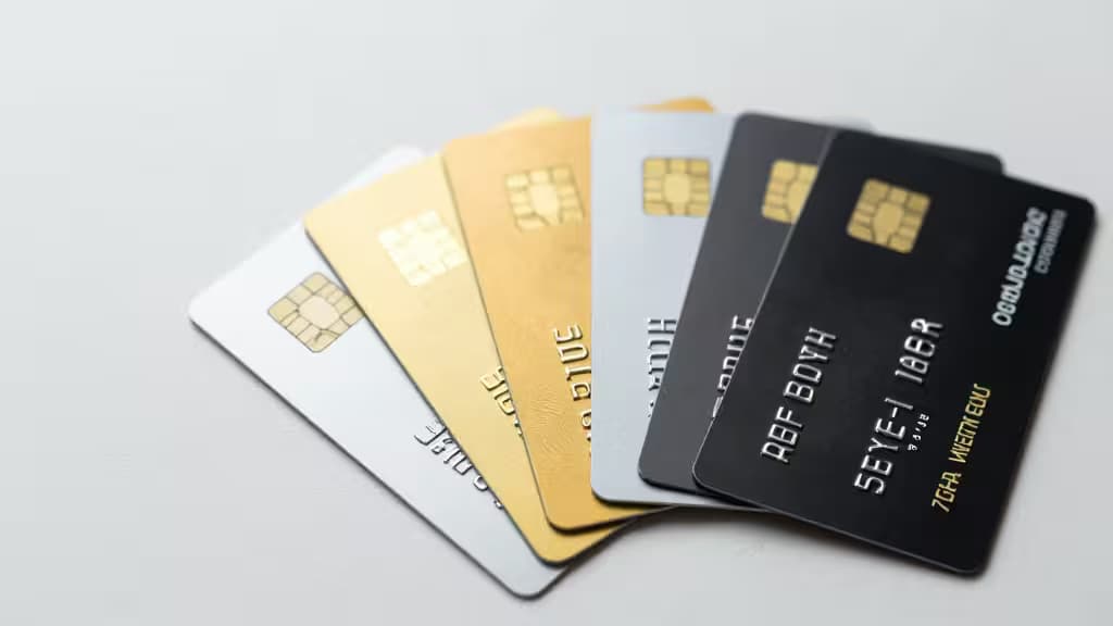 Five credit cards fanned out, showcasing metallic finishes and embossed details on a clean white background.
