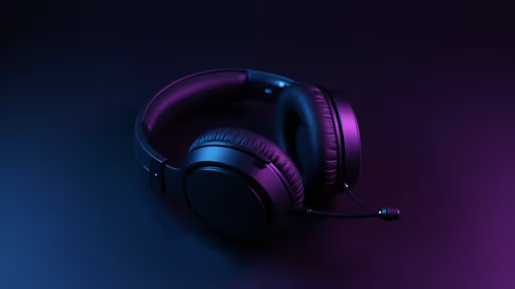 Gaming headset resting on a dark surface with blue and purple ambient lighting