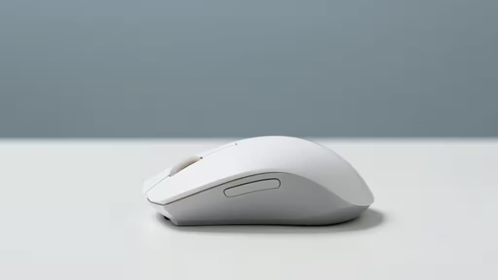 Sleek white vertical ergonomic mouse rests on pristine white desk, highlighting minimalist design for carpal tunnel relief.